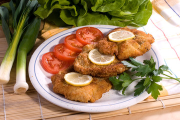wiener schnitzel served - delicious dinner and vegetable