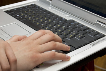 Female Hand Resting on Laptop with Russian Keyboard
