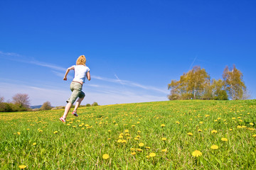 young female having fun on flowery meadow