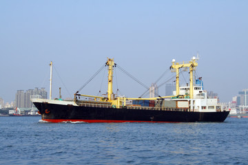 Fototapeta premium Cargo ship leaving the harbor