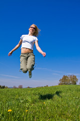 young female having fun on flowery meadow