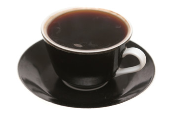 The black cup with fragrant coffee costs on a table