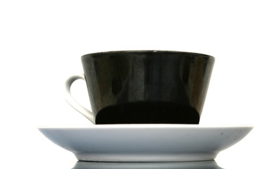 The black cup with fragrant coffee costs on a table