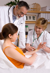 Obraz na płótnie Canvas Doctors consulting their patient