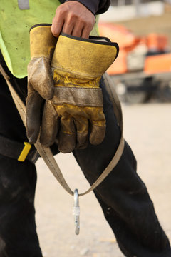 Construction Worker Takes Off Gloves After A Days Work