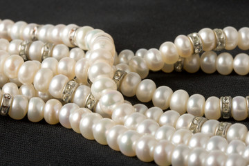 Pearl necklace on black background