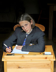 school girl working at desk