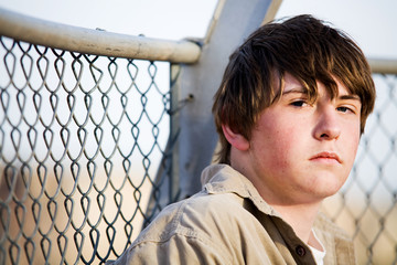 teen portrait against fence