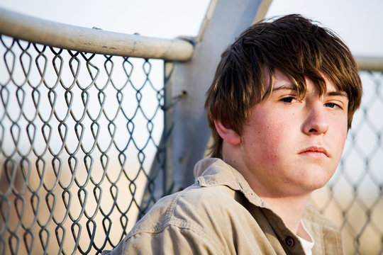 teen portrait against fence