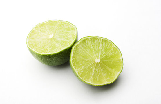 a lime cut in two on a white background