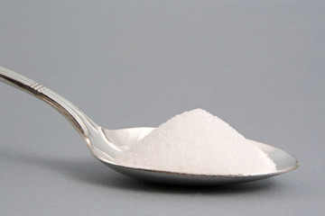 pouring sugar in spoon