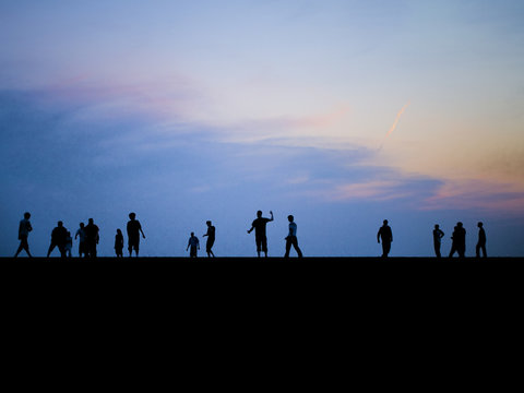 People Playing on Horizon at Dusk/Sunset
