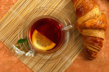 tea with lemon and croissant