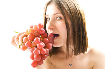 Beautiful young woman with red grape