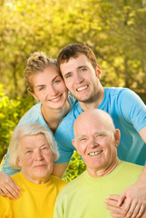 Young couple and their grandparents outdoors