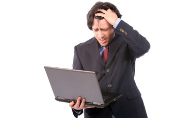Young worried business man working with laptop