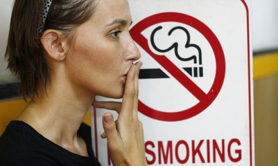 Lady smoking a non-smoking panel - 7551316
