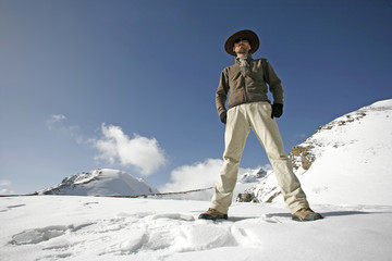 man standing in snow with legs apart, annapurna, nepal