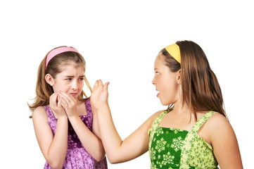 Two young girls fighting one slapping the other and one scared