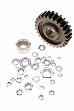 Gear and nuts on white