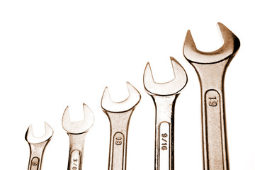 Assorted spanners over white background