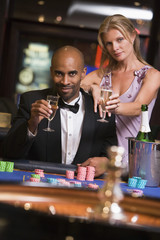 Couple gambling at roulette table
