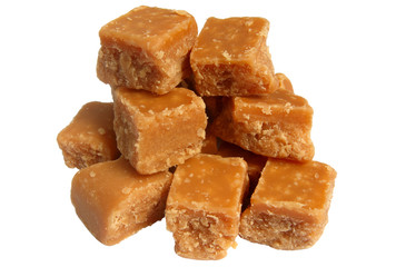 A pile of sweet butter fudge pieces isolated over white