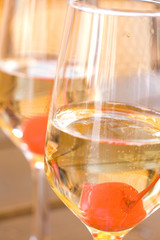 Champagne glasses with red cherry