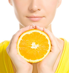 Beautiful woman's face with juicy orange