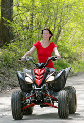 woman in red on four wheeler