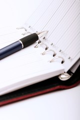 Pen on business notebook. Close-up