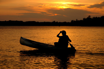 Naklejka na ściany i meble Canoe Silhouette in Sunset on a Minnesota Lake