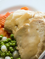 sliced white meat chicken dinner and vegetables