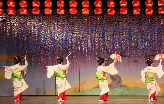 Traditional Japanese dance with Geishas on stage, dancing show in Kyoto, touristic attraction in Japan