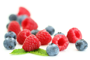 Blueberries and raspberries on white