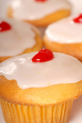 Golden cupcakes with lemon frosting and cherry