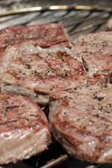 steaks on barbecue grill