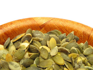 Pumpkin seeds pepitas in wooden dish