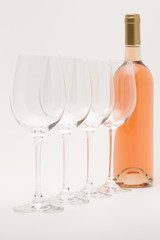 rose wine bottle with wineglasses lined up