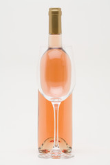 rose wine bottle with empty glass in front