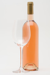 rose wine bottle with empty glass in front