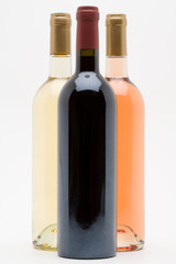 red white and rose wine bottles