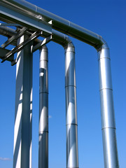 Industrial zone, steel pipelines on blue sky