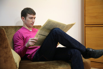 Young man with newspaper