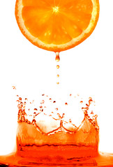 Fresh orange jumping into water with a splash