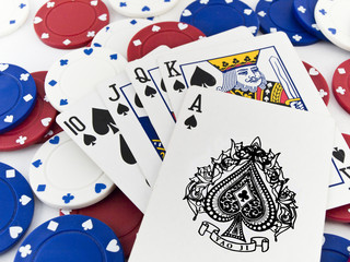 Red White and Blue Poker Chips and Royal Flush on White Backgrou