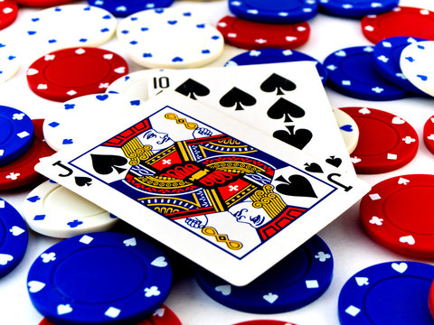 Red White and Blue Poker Chips and Black Jack on White Backgroun