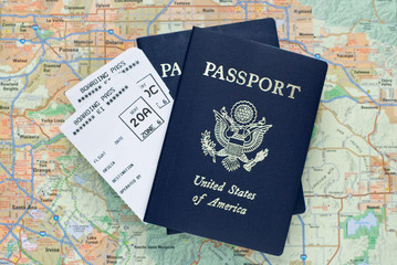 Airplane boarding passes and American passports over map