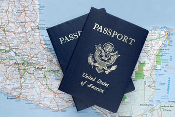 Two American passports over map of Mexico, Caribbean