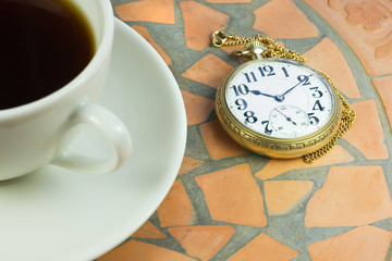 watching time on pocket watch during coffee break